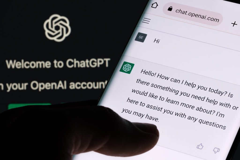 ChatGPT chat bot screen seen on smartphone and laptop display